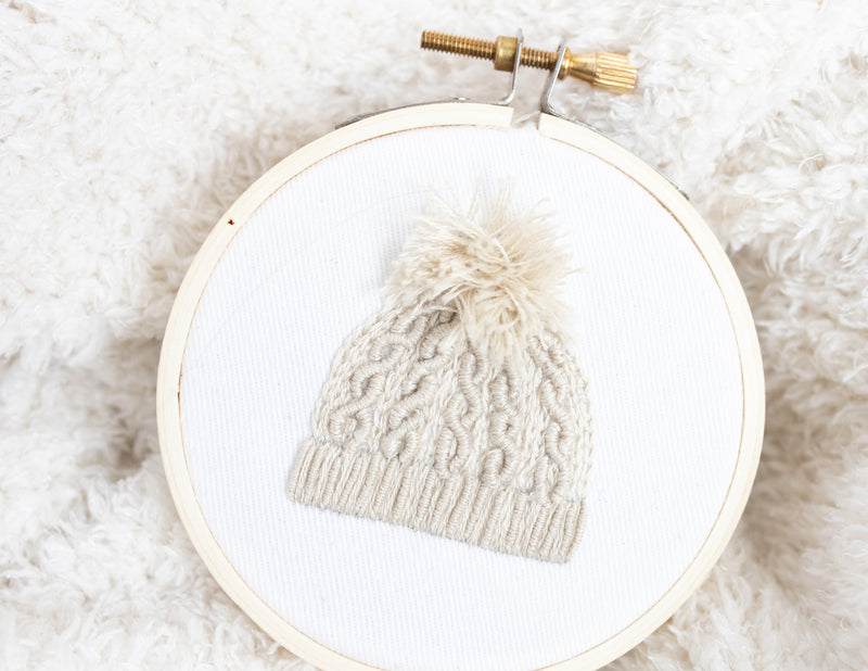 Quick embroidery ornament project of cable knit hat