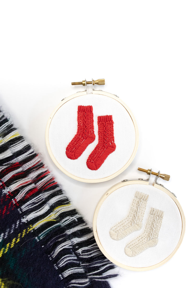 Mini embroidered tree ornaments featuring red and white socks
